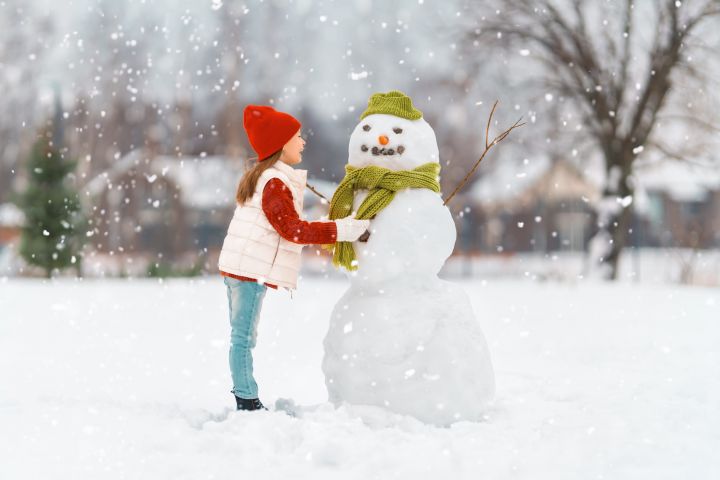 girl-playing-with-a-snowman-2022-01-17-20-44-00-utc-scaled.jpg