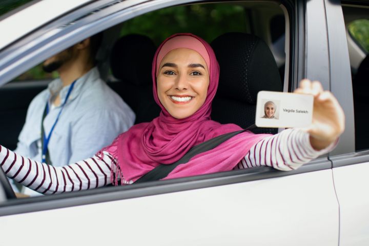 joyful-islamic-lady-in-hijab-demonstrating-driver-2021-11-03-19-49-10-utc-scaled.jpg