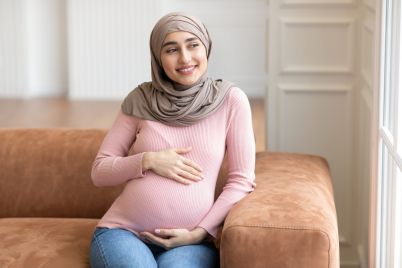 joyful-pregnant-muslim-woman-wearing-hijab-touchin-2021-09-04-02-50-43-utc-scaled.jpg