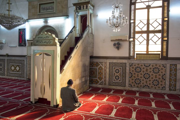 rear-view-of-man-kneeling-on-floor-in-mosque-pray-2022-03-04-02-34-34-utc-scaled.jpg