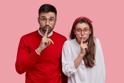 young-surprised-couple-make-silence-sign-stand-cl-2022-02-08-02-07-42-utc-scaled.jpg